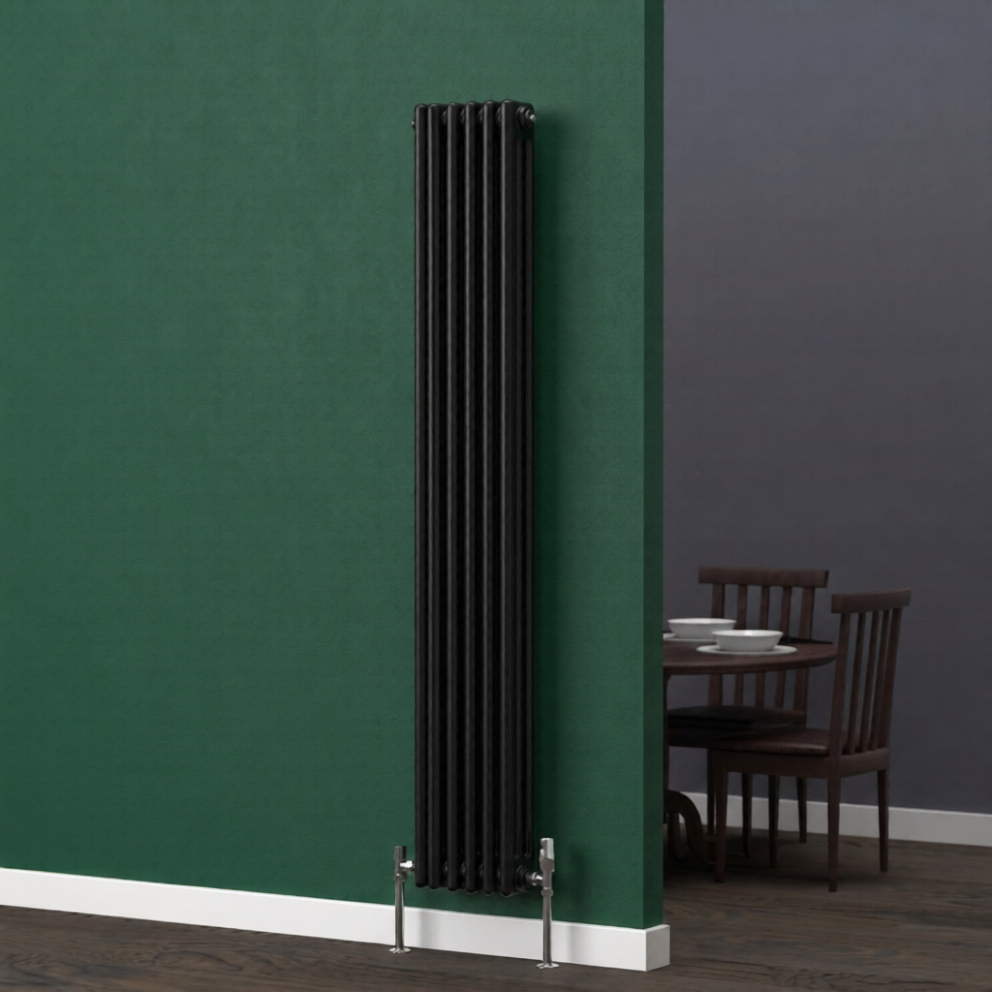Tall black vertical two column radiator mounted on a dark green wall in a dining room