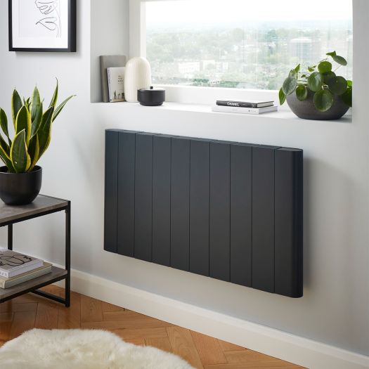 Anthracite grey flat panel aluminium electric radiator mounted beneath a window